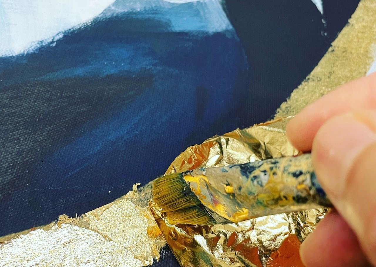 Gold leaf being applied to a painting in the PEPS Arts studio