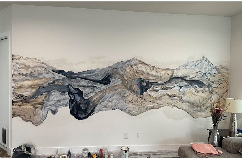Hand painted mountain mural by Joanna Purvis across a bedroom wall