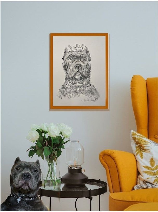 Framed pet portrait sketch by Joanna Purvis beside a yellow armchair